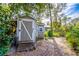 Exterior view of a painted shed with trees in the background, in need of some maintenance at 1720 Overlook Rd, Longwood, FL 32750