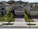 Aerial view of a two-story house with a brick driveway and a well-maintained lawn at 1726 Tree Shade Dr, Davenport, FL 33837