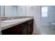 Bathroom with double vanity and dark brown cabinets at 1726 Tree Shade Dr, Davenport, FL 33837