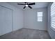 Bright bedroom with ceiling fan and neutral carpeting at 1726 Tree Shade Dr, Davenport, FL 33837