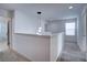 Upstairs hallway with neutral carpeting and lighting at 1726 Tree Shade Dr, Davenport, FL 33837