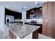 Modern kitchen with granite countertops, stainless steel appliances, and an island at 1726 Tree Shade Dr, Davenport, FL 33837