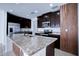 Modern kitchen island with granite countertop and sink at 1726 Tree Shade Dr, Davenport, FL 33837