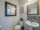 Half bathroom with pedestal sink and toilet at 17454 Chateau Pine Way, Clermont, FL 34711