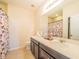 Bathroom with double vanity and shower at 17454 Chateau Pine Way, Clermont, FL 34711