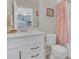 Bathroom with a tub/shower combo with a vanity with storage, and a floral shower curtain adding character at 17584 Saw Palmetto Ave, Clermont, FL 34714