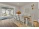 Dining room with a large wooden table and white chairs, overlooking the patio at 17584 Saw Palmetto Ave, Clermont, FL 34714