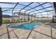 Beautiful screened pool and spa with a paved deck at 17584 Saw Palmetto Ave, Clermont, FL 34714