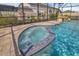 Inviting spa with blue tile accents and bubbling water at 17584 Saw Palmetto Ave, Clermont, FL 34714