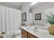 Bathroom with a marble countertop vanity, shower/tub combo, and white toilet at 20620 Maxim Pkwy, Orlando, FL 32833