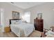 Guest bedroom with queen bed, dresser and wood-look floors at 20620 Maxim Pkwy, Orlando, FL 32833