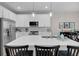 White kitchen with large island and stainless steel appliances at 20620 Maxim Pkwy, Orlando, FL 32833