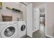 Laundry room with washer, dryer, and built-in shelving at 20620 Maxim Pkwy, Orlando, FL 32833