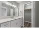 Modern bathroom with white vanity, quartz countertop and a linen closet at 2201 Kentucky Derby Dr, Orlando, FL 32825