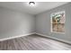 Well-lit bedroom featuring wood-look floors and a window at 2201 Kentucky Derby Dr, Orlando, FL 32825