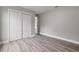 Bedroom with wood-look floors and double-door closet at 2201 Kentucky Derby Dr, Orlando, FL 32825