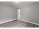 Spacious bedroom with wood-look floors and access to another room at 2201 Kentucky Derby Dr, Orlando, FL 32825