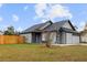 Charming gray house with a fenced backyard and spacious lawn at 2201 Kentucky Derby Dr, Orlando, FL 32825