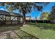 Large backyard with a wooden fence and mature trees at 2540 Albany Dr, Kissimmee, FL 34758