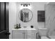 Modern bathroom with white vanity, marble shower, and round mirror at 2540 Albany Dr, Kissimmee, FL 34758