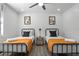 Bright bedroom with two twin beds, orange bedding, and modern decor at 2540 Albany Dr, Kissimmee, FL 34758