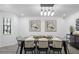 Modern dining room with black chairs and a stylish chandelier at 2540 Albany Dr, Kissimmee, FL 34758