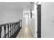 Upstairs hallway with dark wood railing and updated flooring at 2540 Albany Dr, Kissimmee, FL 34758