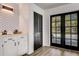 Wet bar with black cabinets and french doors leading to pool at 2540 Albany Dr, Kissimmee, FL 34758