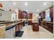 Modern kitchen with dark wood cabinets and granite counters at 2556 Antlia Dr, Orlando, FL 32828