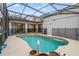 Inviting kidney-shaped swimming pool with a screened enclosure at 2556 Antlia Dr, Orlando, FL 32828