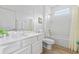 Clean bathroom with white vanity, bathtub, and wood-look tile floor at 2639 Calistoga Ave, Kissimmee, FL 34741