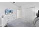 Bright bedroom with gray bedding, white dresser, and mounted TV at 2639 Calistoga Ave, Kissimmee, FL 34741