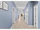 Light and bright hallway with light wood-look tile floors at 2639 Calistoga Ave, Kissimmee, FL 34741