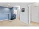 Upstairs hallway with blue walls, carpet, and access to bedrooms at 2639 Calistoga Ave, Kissimmee, FL 34741