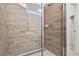 Modern shower with wood-look tile and glass enclosure at 2639 Calistoga Ave, Kissimmee, FL 34741