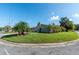 Ranch home on corner lot with circular driveway and lush landscaping at 26608 Bermuda Dr, Tavares, FL 32778