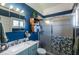 Clean bathroom with a blue vanity and glass shower at 26608 Bermuda Dr, Tavares, FL 32778