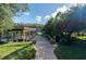 Relaxing dockside patio with brick pathway leading to the water at 26608 Bermuda Dr, Tavares, FL 32778