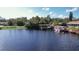 Private dock with boat on a calm canal at 26608 Bermuda Dr, Tavares, FL 32778