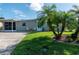 Ranch home with carport, tropical landscaping, and spacious yard at 26608 Bermuda Dr, Tavares, FL 32778