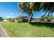 Ranch home with lush lawn and mature palm trees at 26608 Bermuda Dr, Tavares, FL 32778