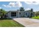 Ranch home with screened porch and a well-maintained yard at 26608 Bermuda Dr, Tavares, FL 32778