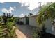 Exterior view of a charming ranch house with a spacious yard and palm trees at 26608 Bermuda Dr, Tavares, FL 32778