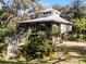 Elevated home on stilts with wrap-around porch and lush landscaping at 2675 Van Arsdale St, Oviedo, FL 32765