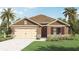 One-story home with brown siding, beige garage door, and red shutters at 2798 Portadown St, Ormond Beach, FL 32174