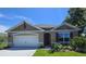 Charming single-story home with well-maintained landscaping, attached garage and neutral color palette at 2798 Portadown St, Ormond Beach, FL 32174