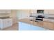 Modern kitchen featuring granite countertops, white cabinetry, and stainless steel appliances at 2798 Portadown St, Ormond Beach, FL 32174