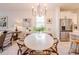 Cozy dining area with modern chandelier, stylish decor, and stainless steel refrigerator at 2950 Timber Hawk Cir, Ocoee, FL 34761