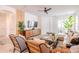 Inviting living room with ceiling fan, chic furnishings, and sliding glass doors to the patio at 2950 Timber Hawk Cir, Ocoee, FL 34761