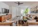 Cozy living room featuring stylish furniture, a ceiling fan, and a sliding glass door to the outdoors at 2950 Timber Hawk Cir, Ocoee, FL 34761